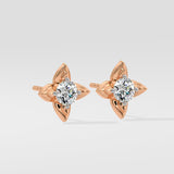 Rose gold diamond earrings with diamond-like stones on a light gray background