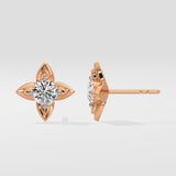 Rose gold diamond stud earrings on a light gray background