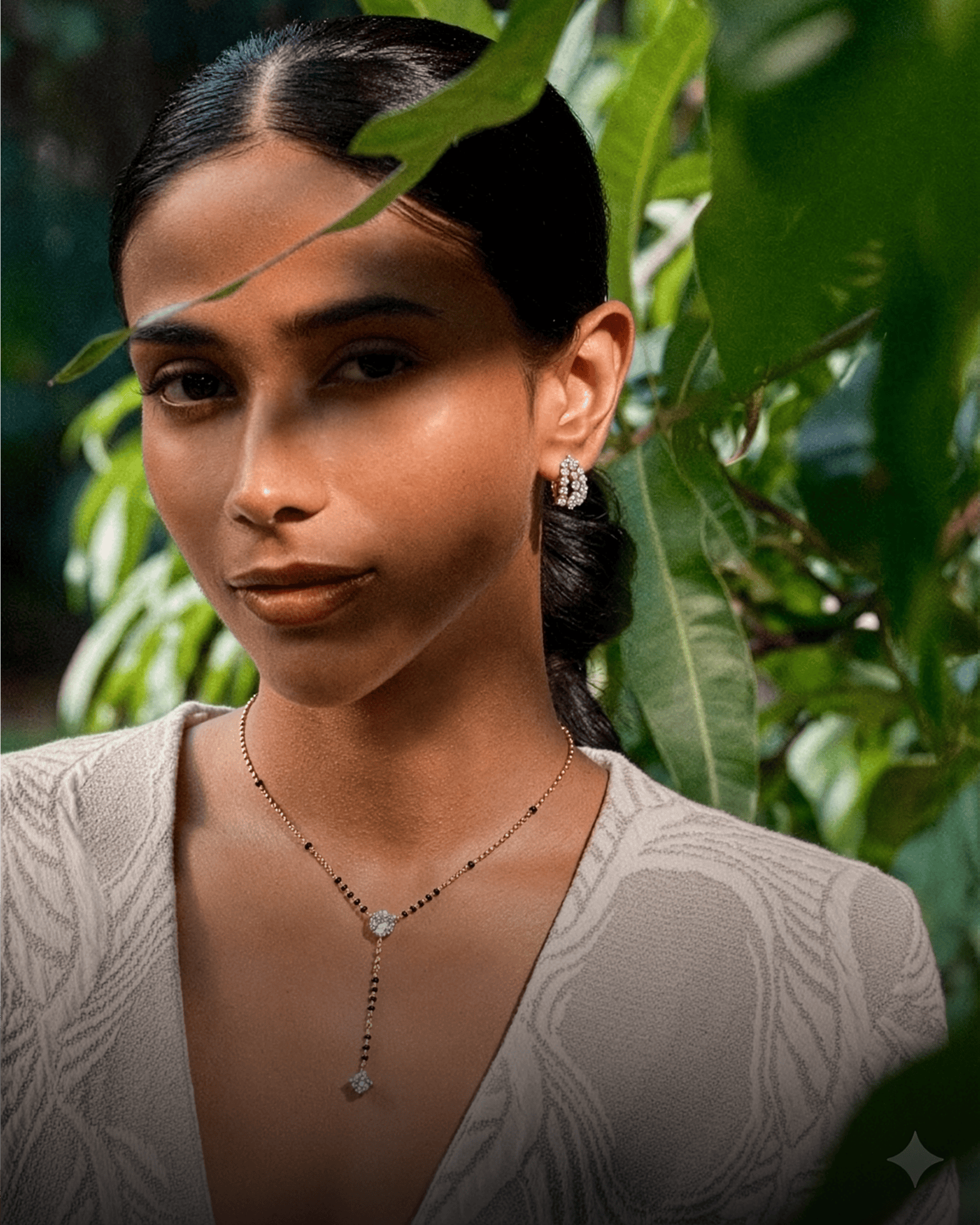 Woman wearing a lab-grown diamond mangalsutra & earrings