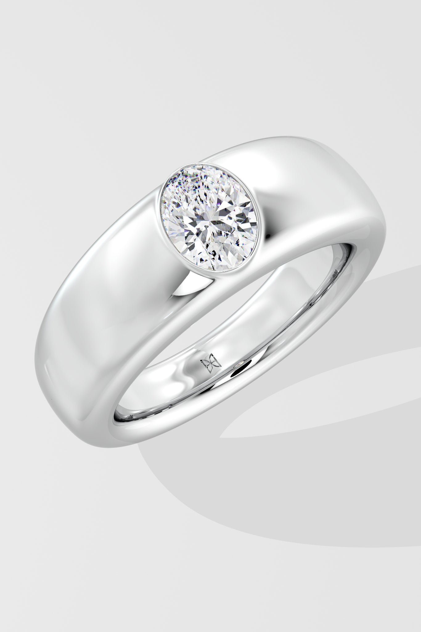 Silver ring with a solitaire diamond on a light gray background