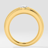 Gold ring with a lab grown diamond on a light gray background