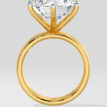 Gold diamond ring with a large diamond on a light gray background