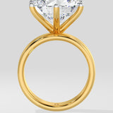 Gold diamond ring with a large diamond on a light gray background