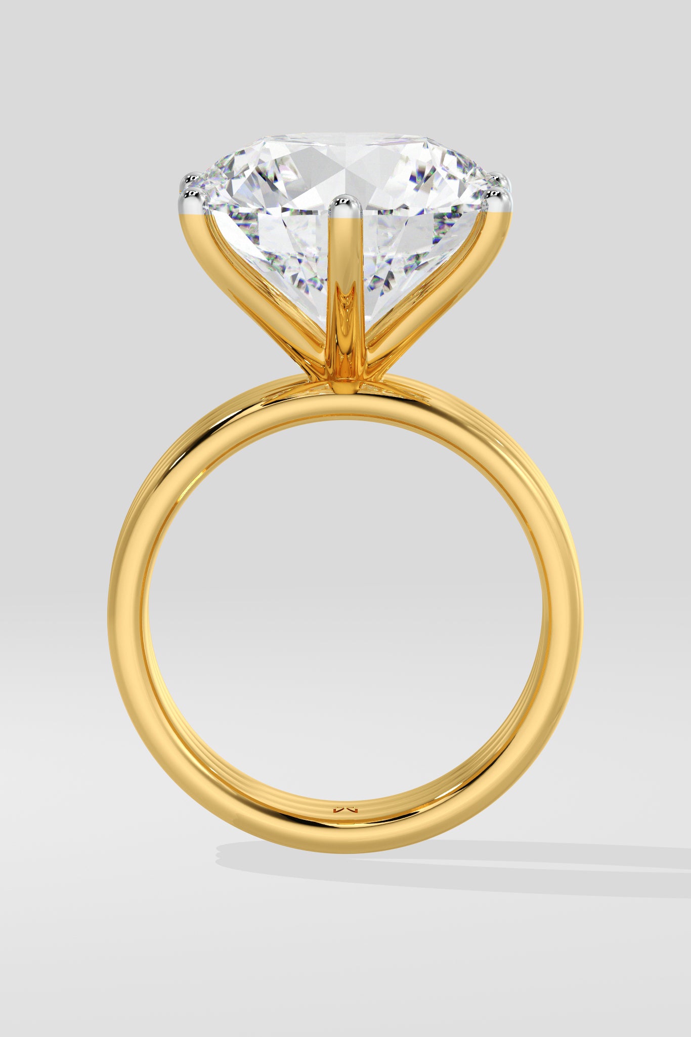 Gold diamond ring with a large diamond on a light gray background
