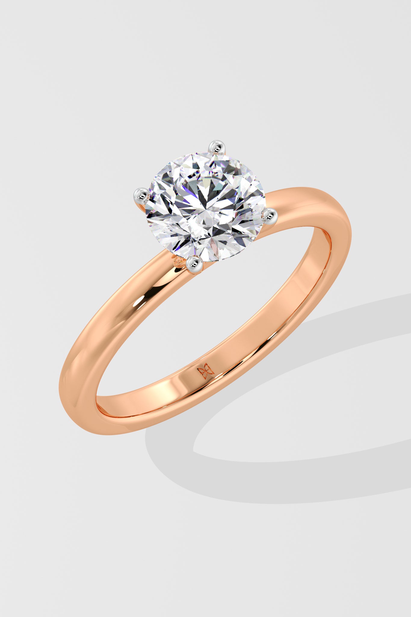 Rose gold ring with a la grown diamond on a light gray background