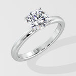 Silver ring with a lab grown diamond on a light gray background