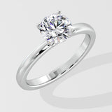 Silver ring with a lab grown diamond on a light gray background