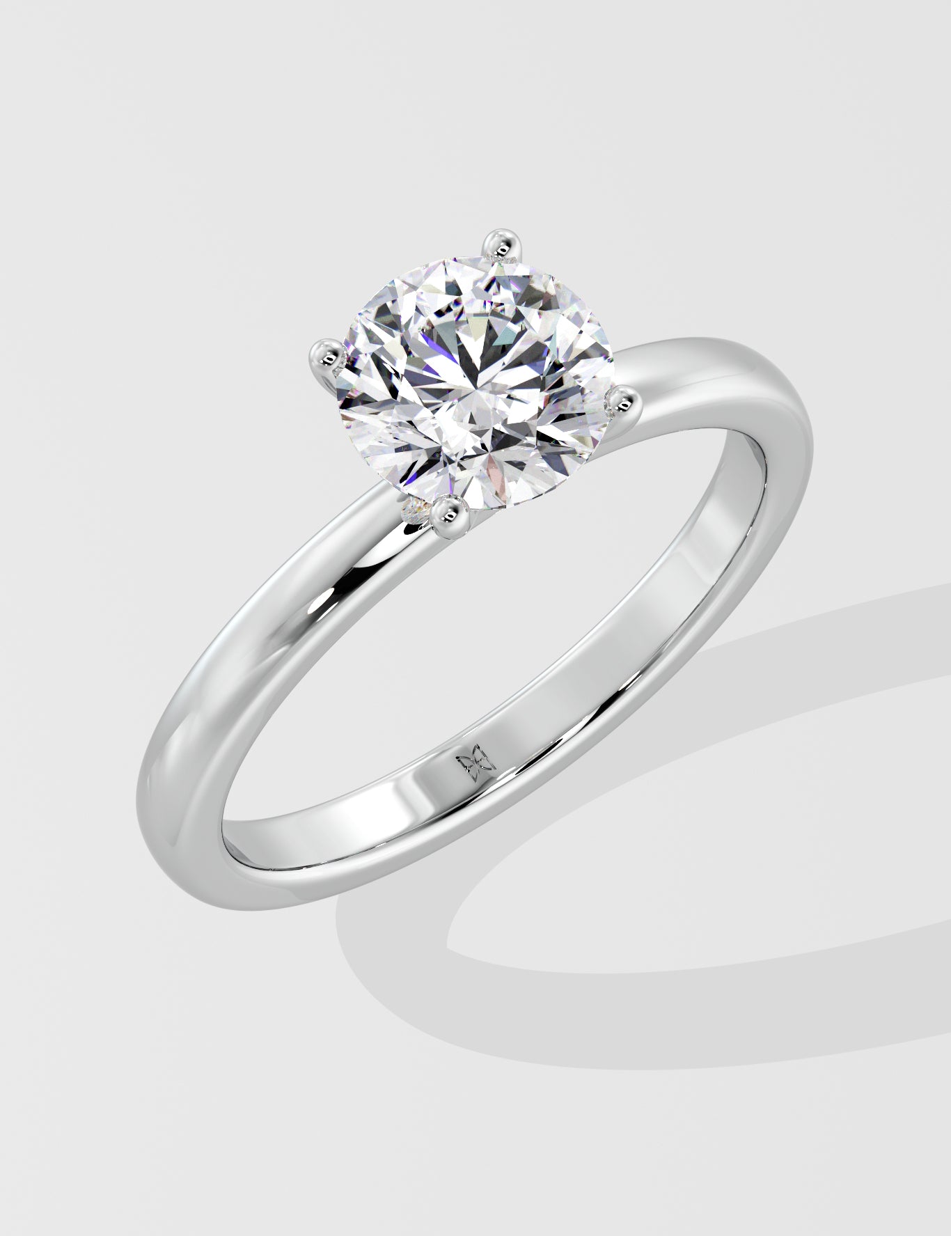 Silver ring with a lab grown diamond on a light gray background