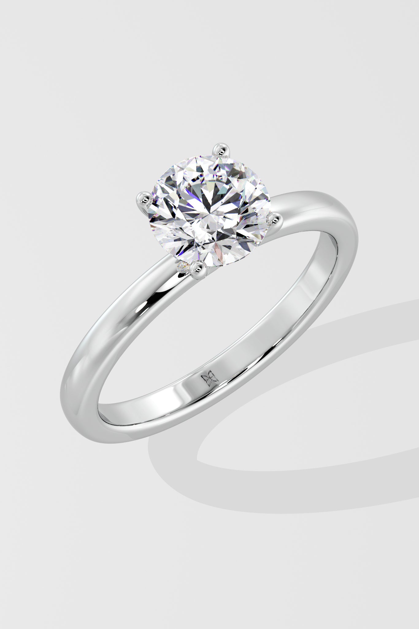 Silver ring with a lab grown diamond on a light gray background