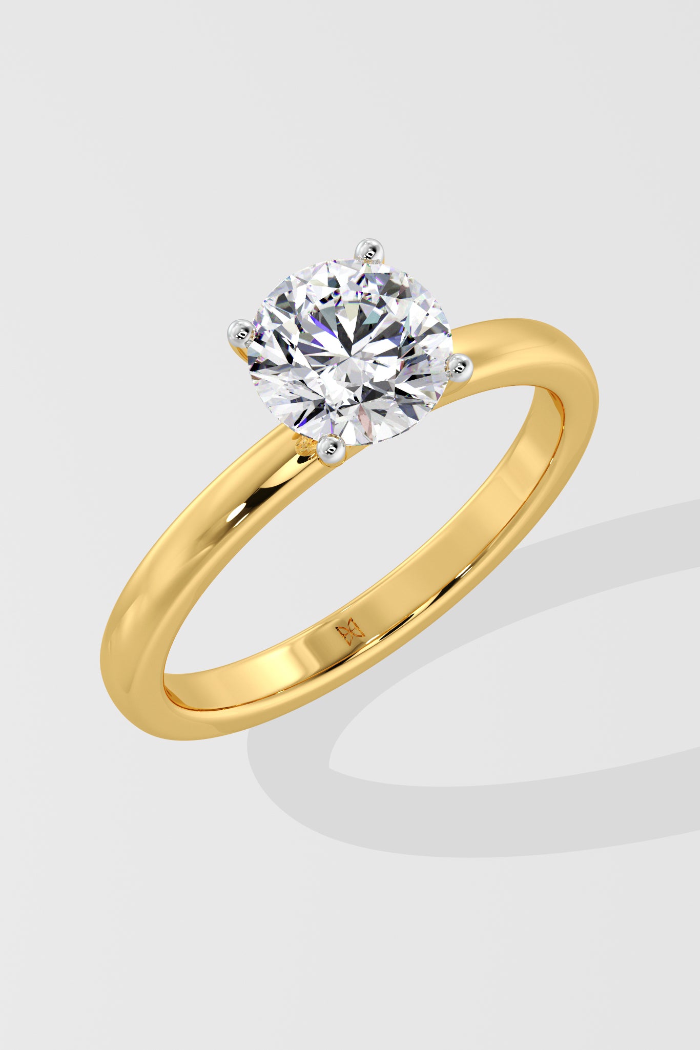 Gold ring with a solitaire diamond on a light gray background