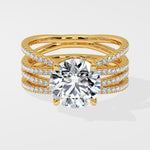 Gold ring with multiple diamond-studded bands on a white background