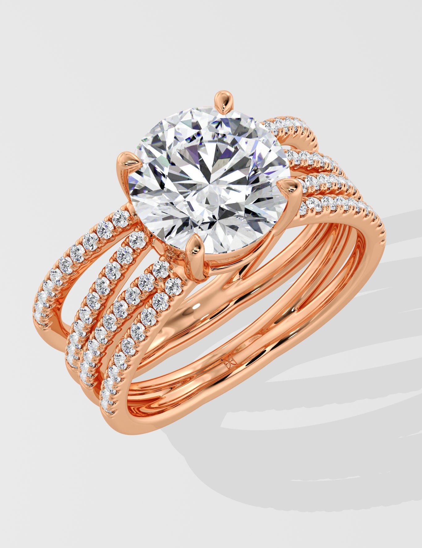 Rose gold ring with a large lab grown diamond and smaller diamonds on the band against a light gray background