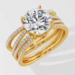 Gold ring with a large lab grown diamond and smaller diamonds on a white background