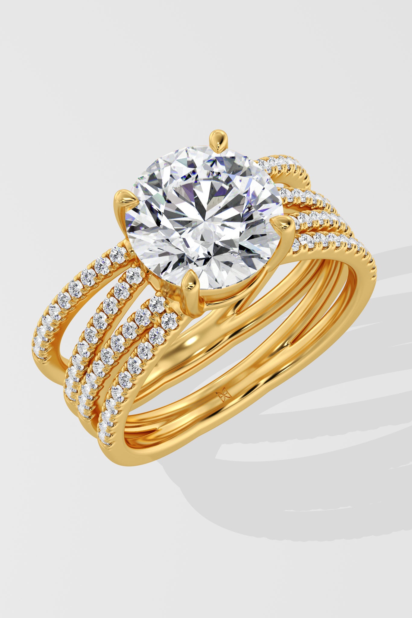 Gold ring with a large lab grown diamond and smaller diamonds on a white background