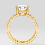 Gold ring with a large central gemstone on a light gray background