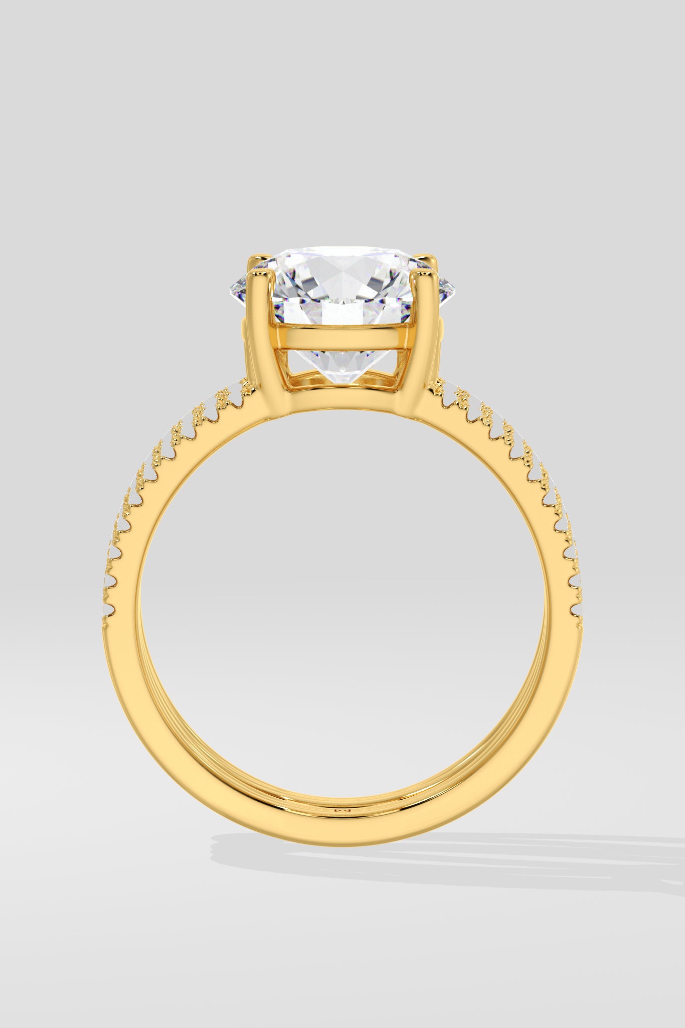 Gold ring with a large central gemstone on a light gray background