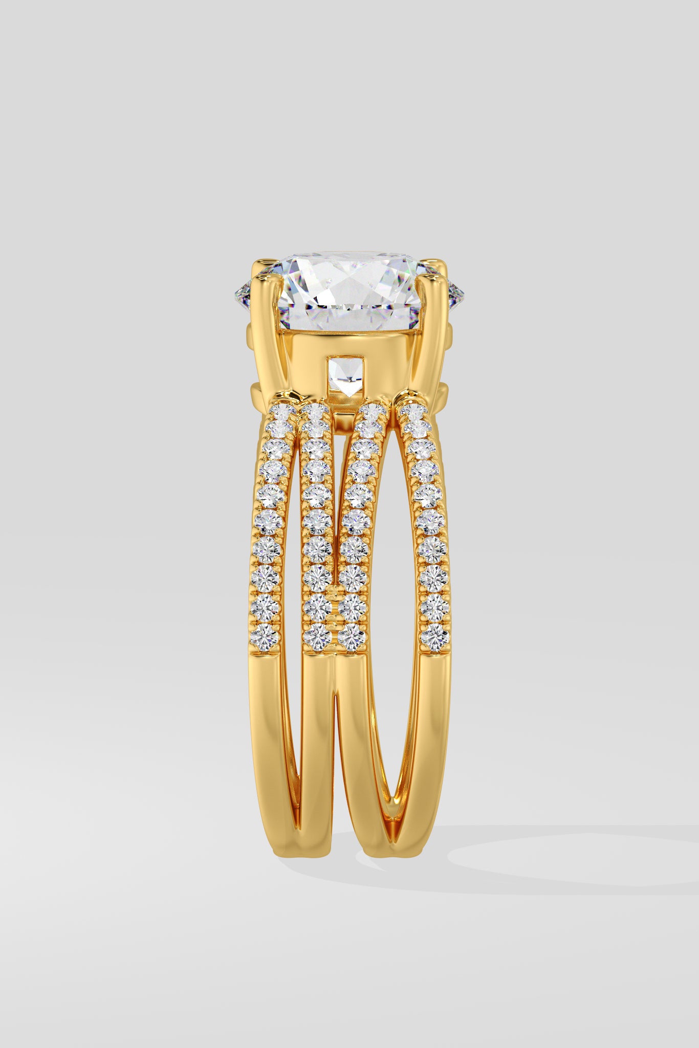 Gold ring with a large lab grown diamond and smaller stones on a light gray background