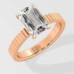 Diamond ring with a Emerald diamond on a white background