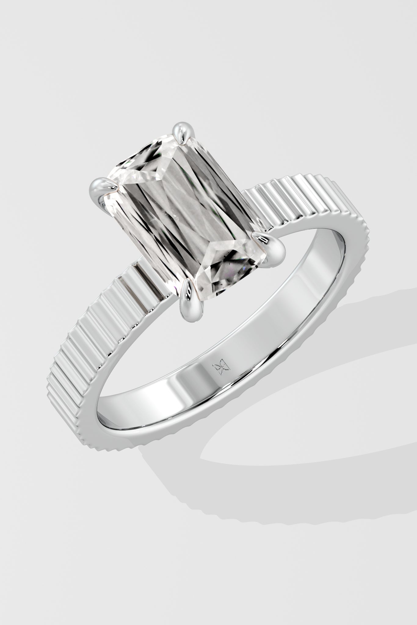 Diamond ring with a Emerald diamond on a white background