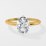 Gold ring with a large diamond on a light gray background