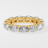 Diamond band ring with oval diamond on a light gray background