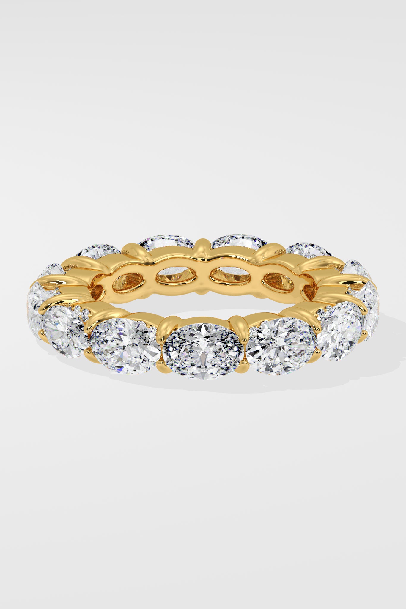 Diamond band ring with oval diamond on a light gray background