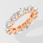 Diamond band ring with oval diamond on a light gray background