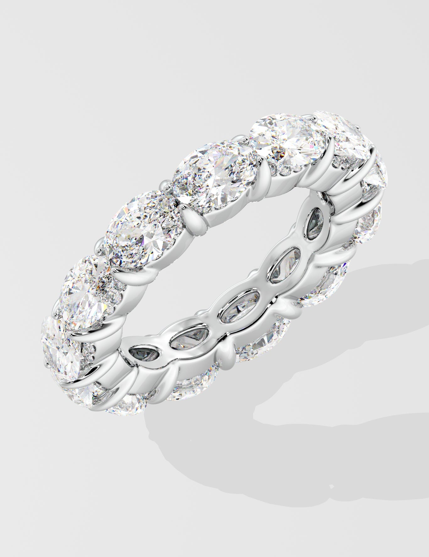 Silver diamond band ring with oval diamond on a light gray background