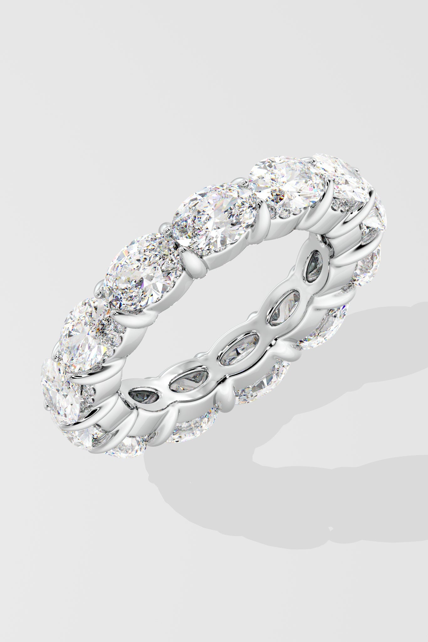 Silver diamond band ring with oval diamond on a light gray background