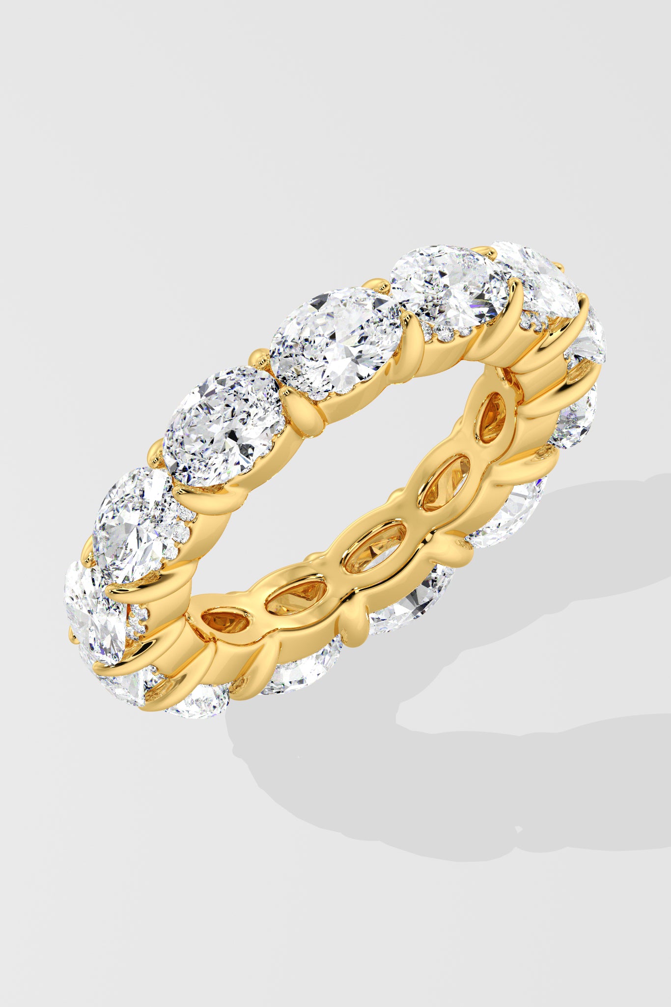 Diamond band ring with oval diamond on a light gray background