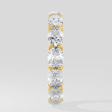 Diamond band ring with oval diamond on a light gray background