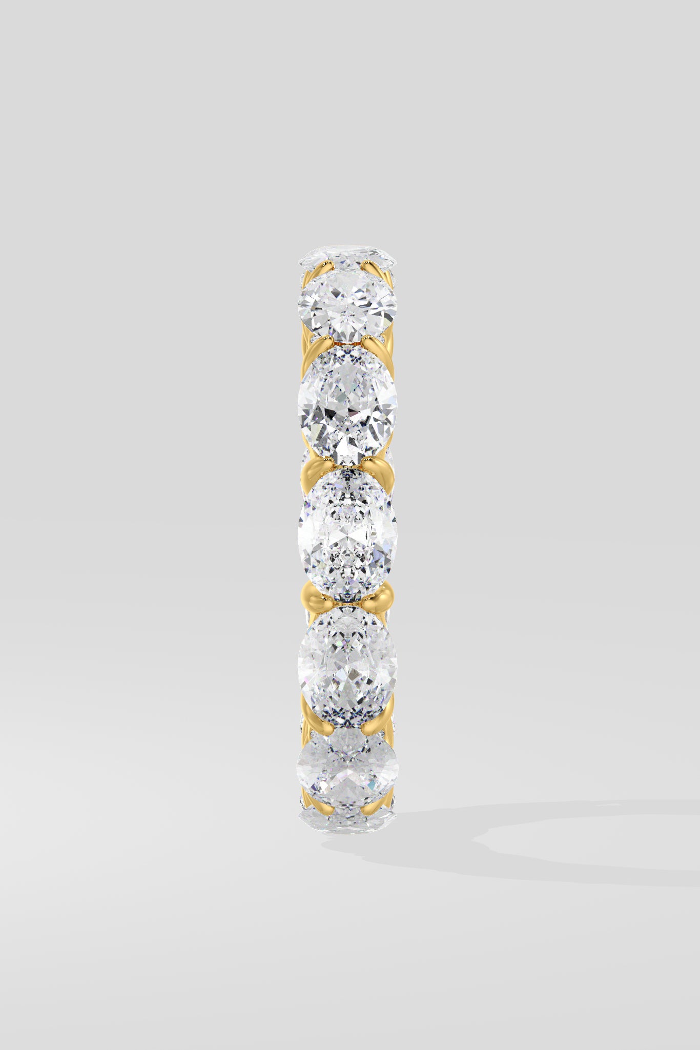 Diamond band ring with oval diamond on a light gray background