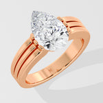 Rose gold pear diamond ring on a light gray background