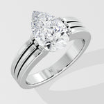 Silver pear diamond ring on a light gray background