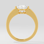 Gold diamond ring on a light grey background
