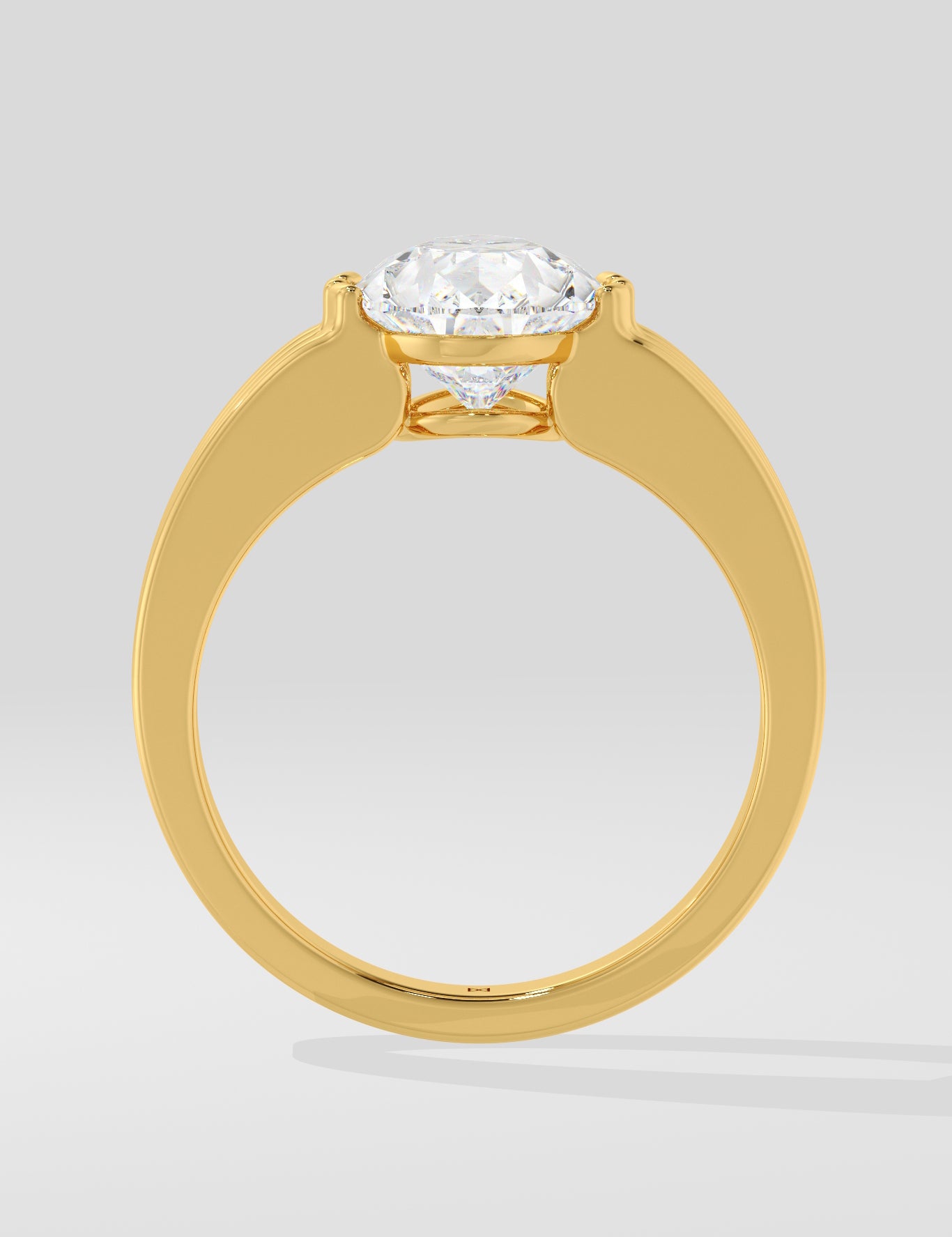 Gold diamond ring on a light grey background