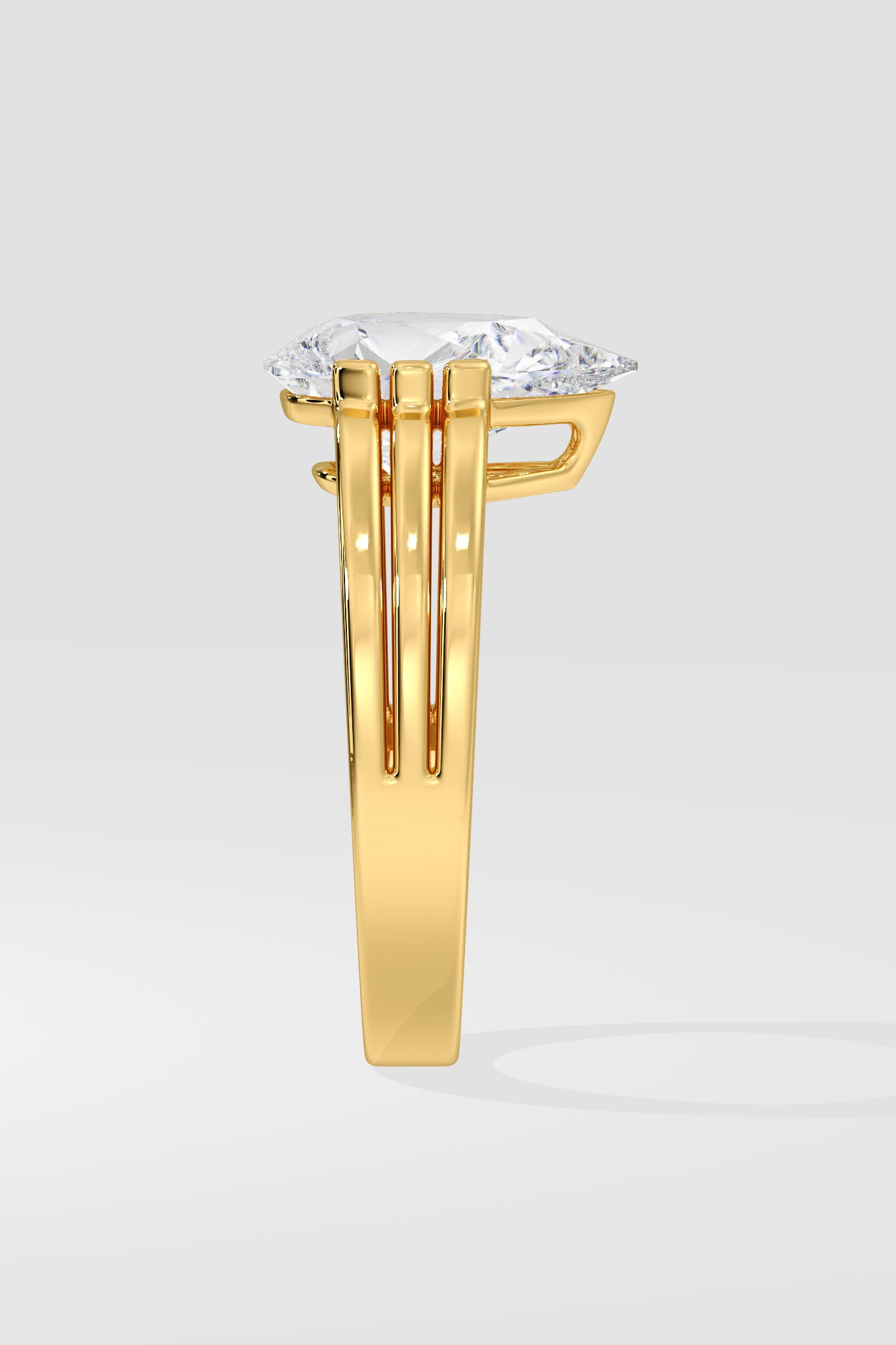 Gold pear diamond ring on a white background