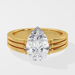 Gold pear diamond ring on a white background