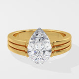 Gold pear diamond ring on a white background