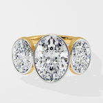 Gold Diamond ring with three round diamonds on a white background