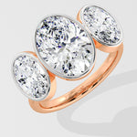 Rose Gold three stone diamond ring on a light gray background