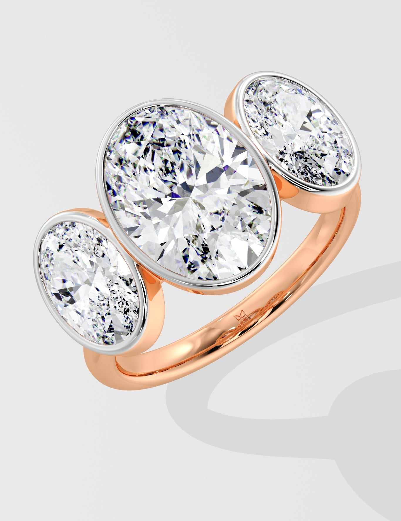 Rose Gold three stone diamond ring on a light gray background