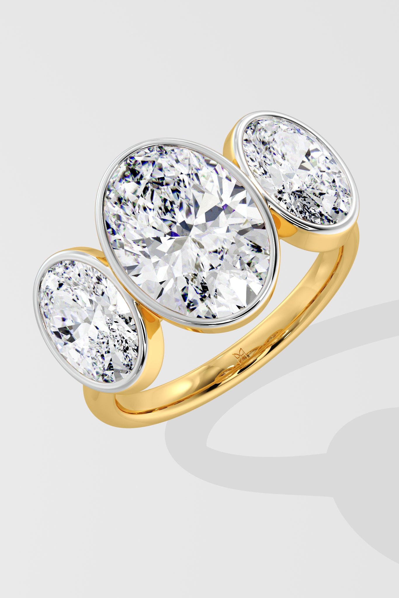 Gold three stone diamond ring on a light gray background