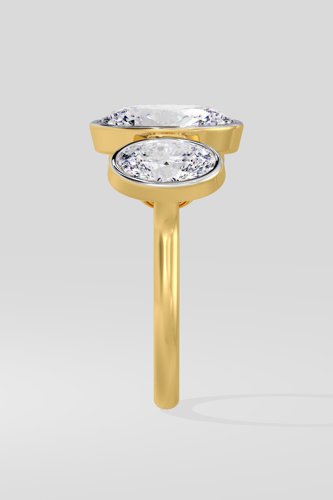 Gold ring with two diamond stones on a light gray background