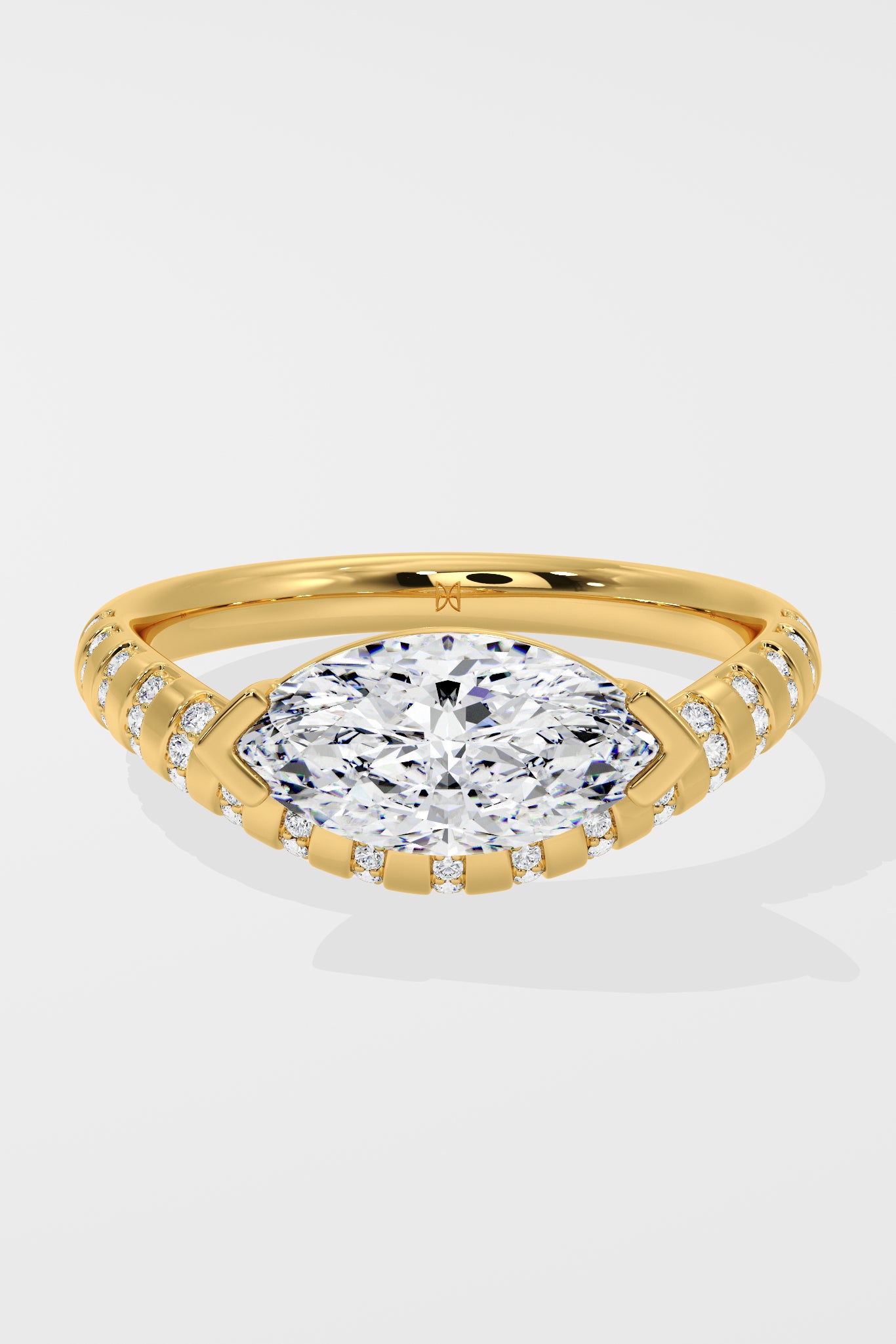 Diamond ring with a large diamond and smaller diamonds on the band against a white background