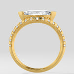 Diamond ring with a large diamond and smaller diamonds on the band against a light gray background