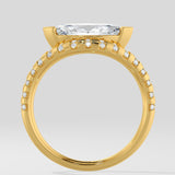 Diamond ring with a large diamond and smaller diamonds on the band against a light gray background